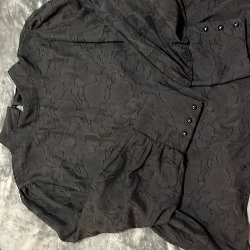 Sheer black blouse long sleeve with buttons on cuffs.